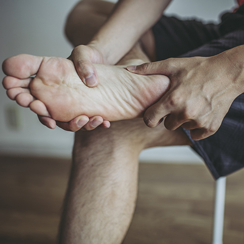 man experiencing foot pain